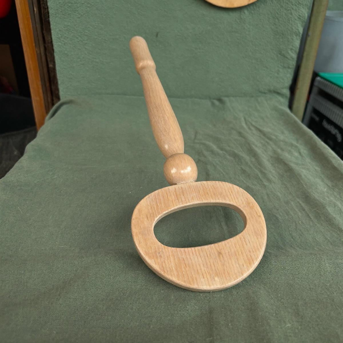 A plain wooden baby rattle.